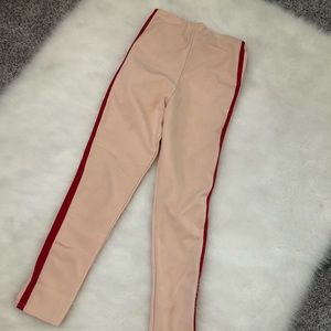 Blush pink pants with a red stripes